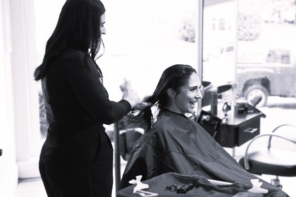 Women getting her hair cut by stylist.