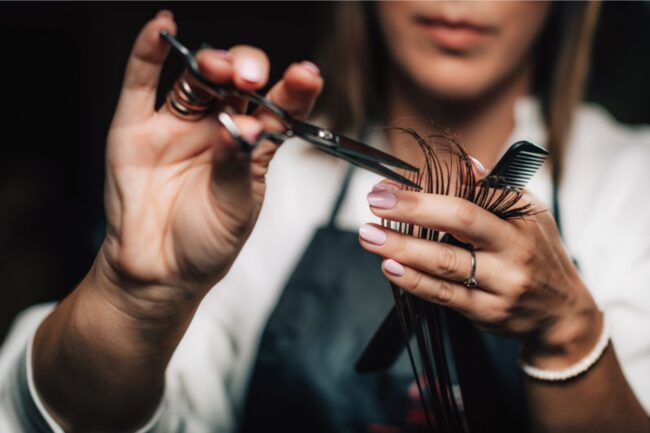 Stylist giving a professional haircut in a modern salon