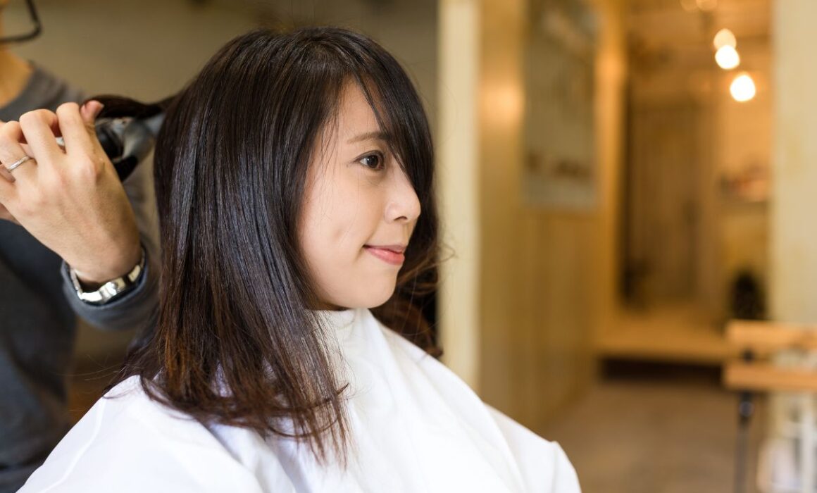 Stylist giving a child a haircut in a bright, kid-friendly salon