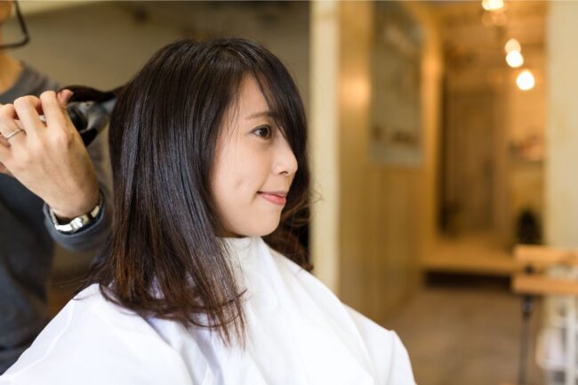 Stylist giving a child a haircut in a bright, kid-friendly salon