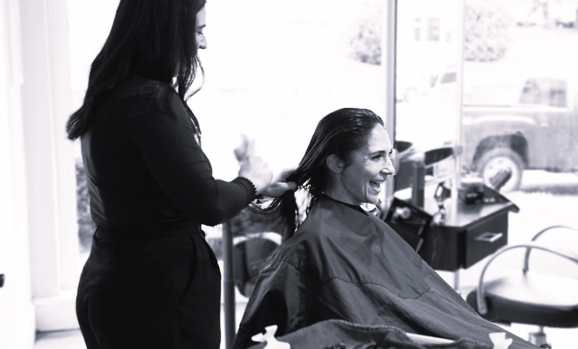 stylist consulting with client for precision haircut at salon in Rye NY
