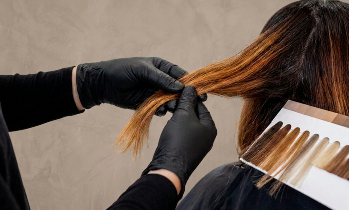 Stylist carefully analyzing client's hair strands during a color correction consultation at a boutique salon.